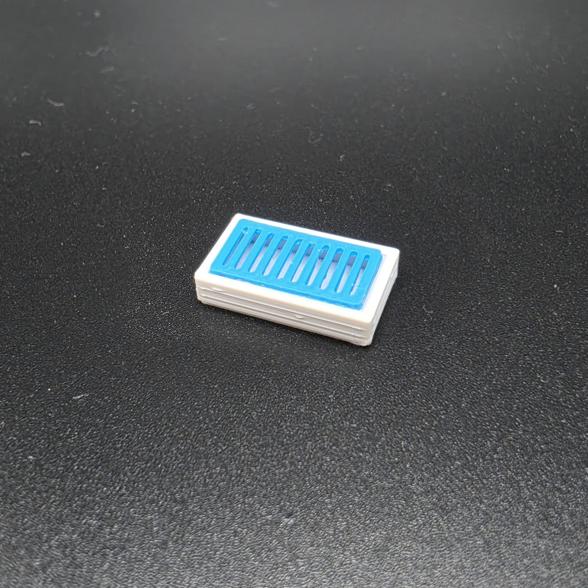 Coloured OO gauge drainage catchpit with grey base and dark slotted grille