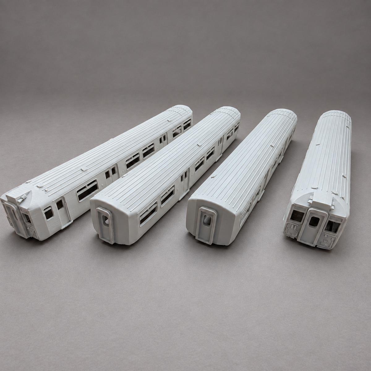 Four OO gauge Class 455 model railway coach bodies fitted with Ignite 3D doorway interior panels